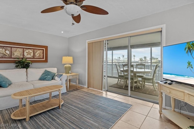 living room with light tile patterned floors and ceiling fan