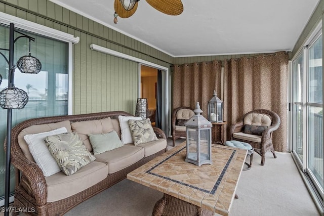 sunroom featuring ceiling fan and baseboard heating