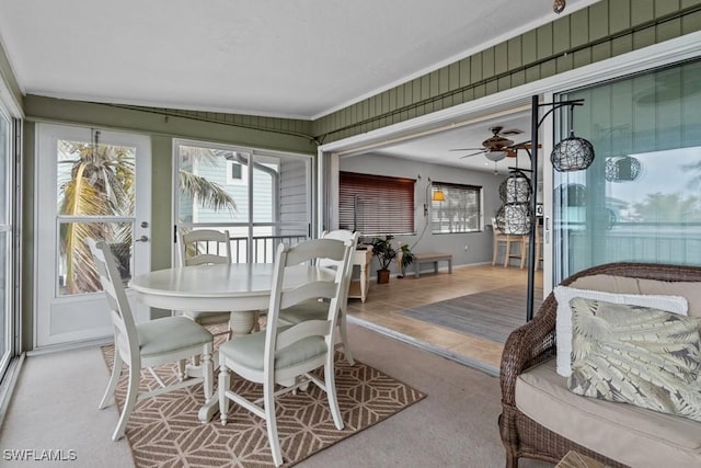 sunroom / solarium featuring ceiling fan