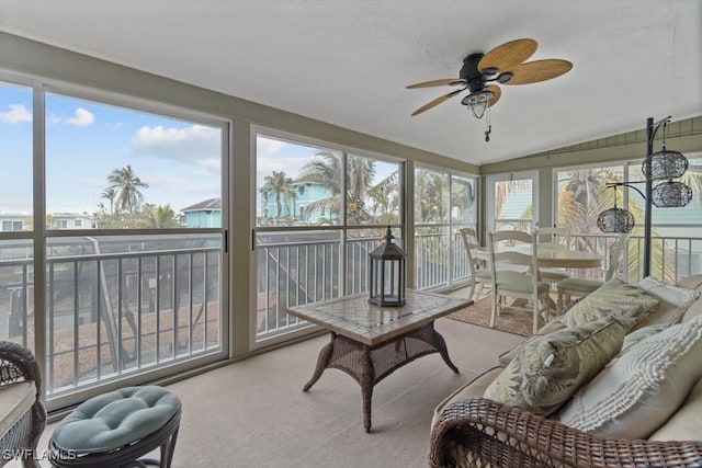 sunroom with ceiling fan and vaulted ceiling