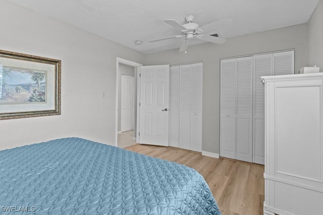 bedroom with multiple closets, ceiling fan, and light wood-type flooring