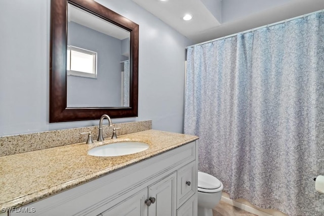 bathroom with vanity and toilet