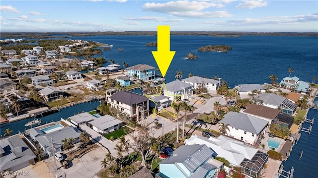 birds eye view of property with a water view