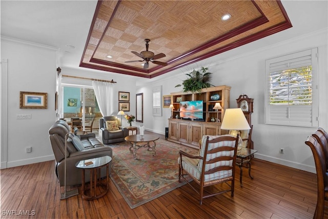 living room with a tray ceiling, hardwood / wood-style flooring, wood ceiling, ceiling fan, and crown molding