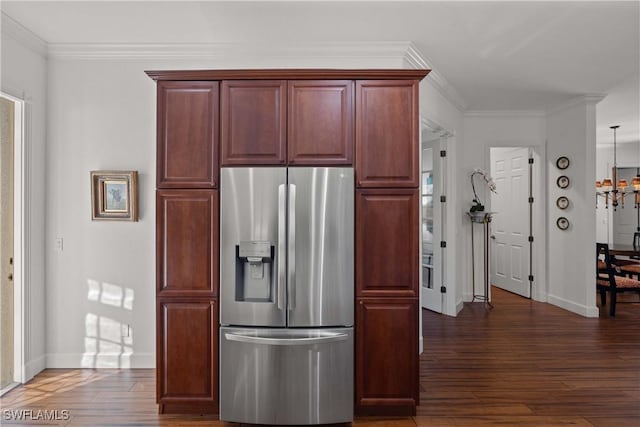 kitchen featuring a notable chandelier, stainless steel fridge, ornamental molding, and dark hardwood / wood-style floors