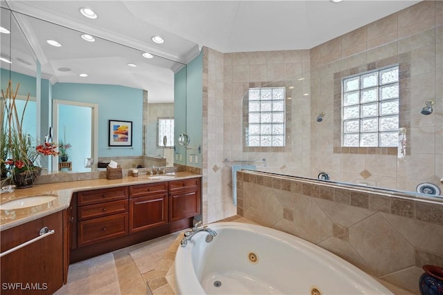 bathroom featuring vanity, plus walk in shower, and plenty of natural light