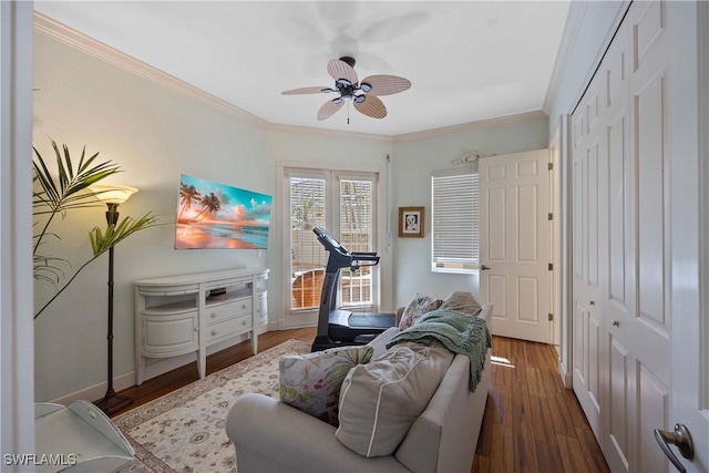 interior space featuring crown molding, ceiling fan, and dark hardwood / wood-style flooring