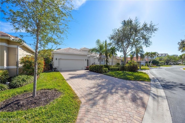 view of front of home with a garage and a front yard