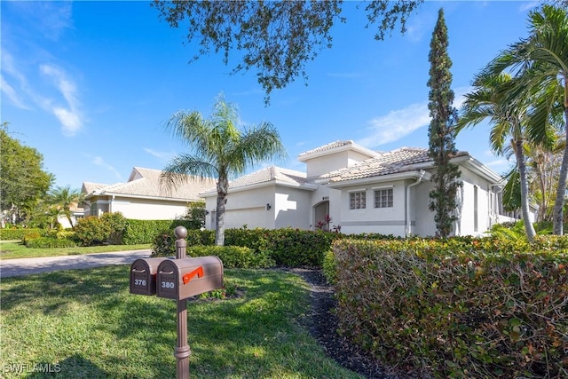 mediterranean / spanish home with a front lawn