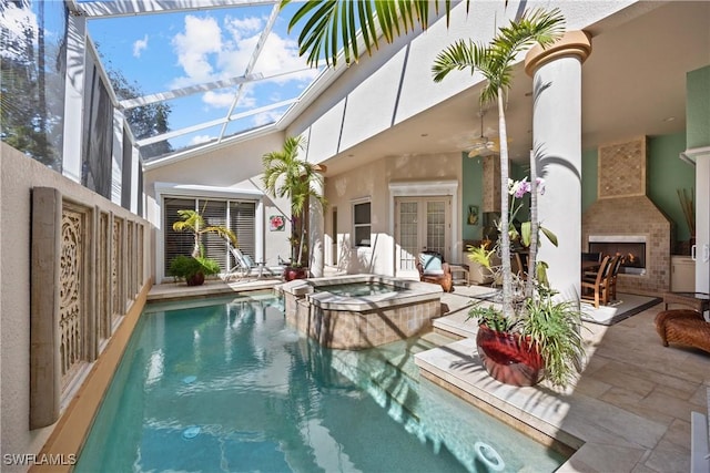 view of swimming pool featuring an outdoor fireplace, ceiling fan, an in ground hot tub, and a patio area