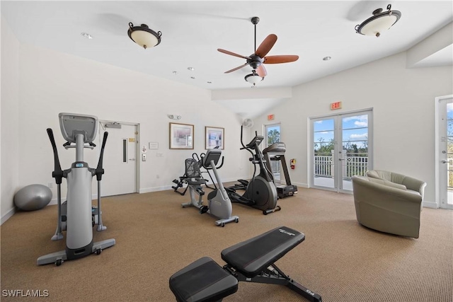 workout area with lofted ceiling, ceiling fan, and french doors