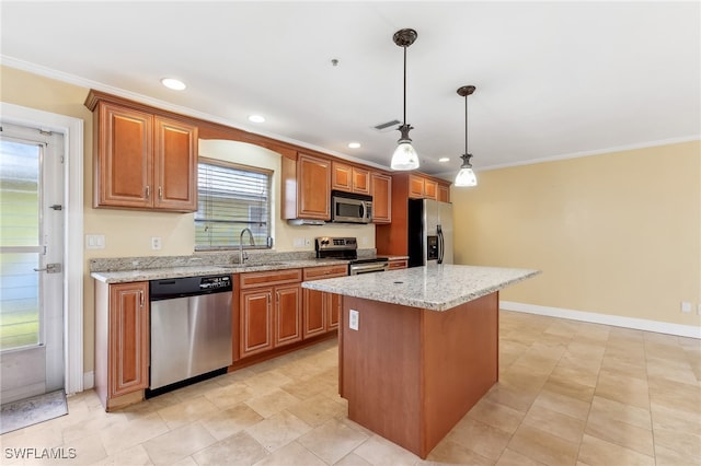 kitchen with appliances with stainless steel finishes, a kitchen island, a sink, and ornamental molding