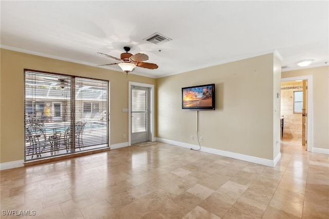 unfurnished room with ornamental molding, a ceiling fan, visible vents, and baseboards