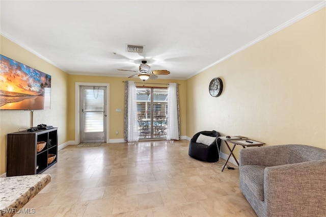 living area featuring baseboards, a ceiling fan, visible vents, and crown molding