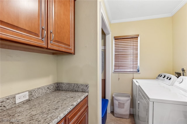 laundry area with light tile patterned flooring, washing machine and clothes dryer, cabinet space, and crown molding