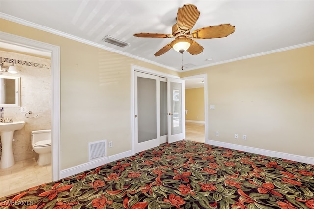 bedroom with baseboards, visible vents, and crown molding