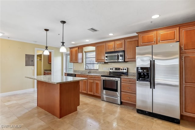 kitchen with a kitchen island, a sink, visible vents, appliances with stainless steel finishes, and brown cabinetry