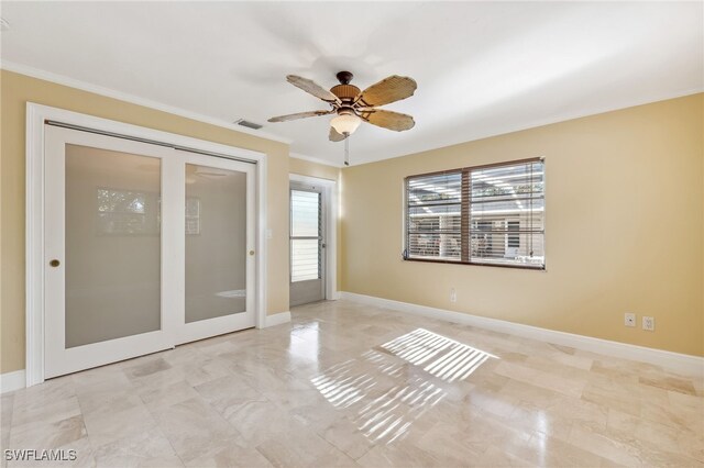 empty room with visible vents, baseboards, and ornamental molding