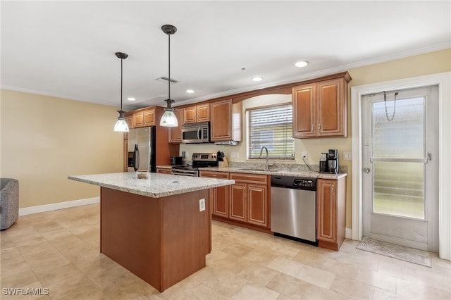 kitchen featuring ornamental molding, light stone counters, a center island, stainless steel appliances, and a sink