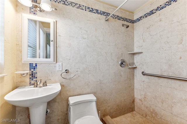 bathroom featuring tiled shower and toilet