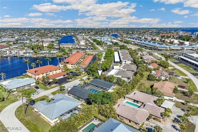 drone / aerial view featuring a water view and a residential view