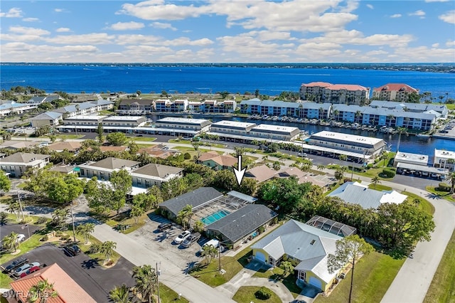 drone / aerial view with a water view and a residential view