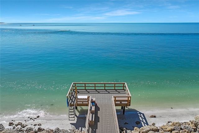 dock area with a water view and a beach view