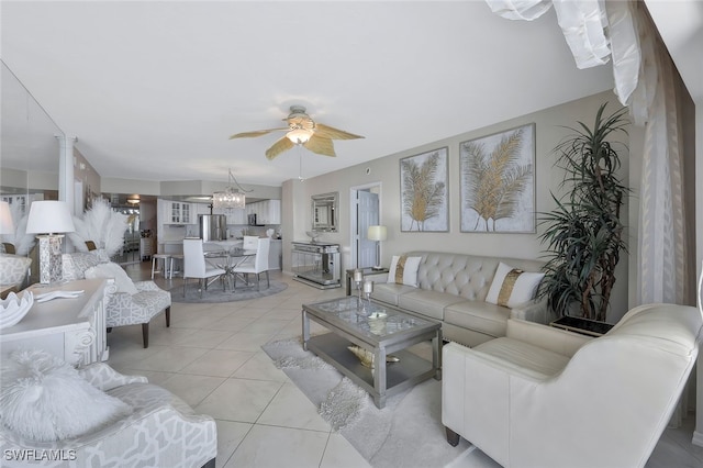 tiled living room featuring ceiling fan with notable chandelier