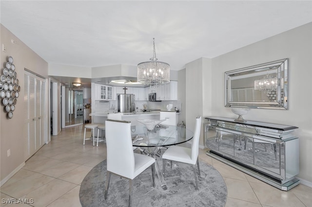 tiled dining room featuring a notable chandelier