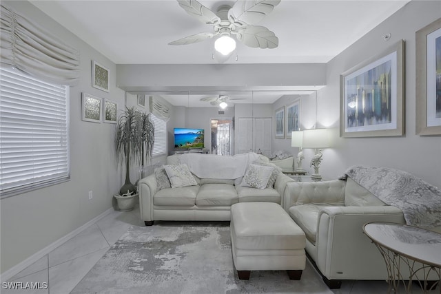 living room featuring light tile patterned flooring and ceiling fan