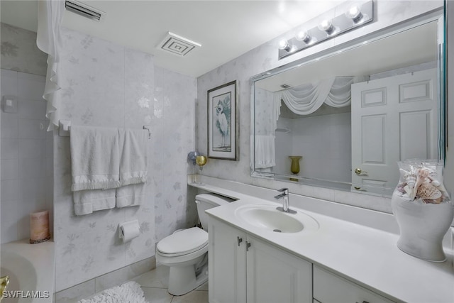 bathroom with tile patterned flooring, vanity, and toilet