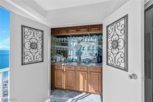 1020 S Collier Blvd Unit 203, Marco Island, FL 34145 - bar with wet bar, a water view, and tile patterned floors
