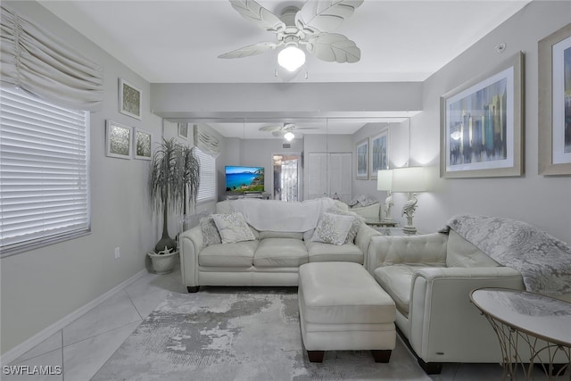 1020 S Collier Blvd Unit 203, Marco Island, FL 34145 - living room featuring a ceiling fan, baseboards, a wealth of natural light, and tile patterned flooring