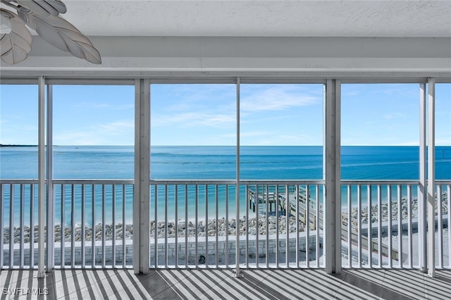 1020 S Collier Blvd Unit 203, Marco Island, FL 34145 - unfurnished sunroom with a water view and a view of the beach
