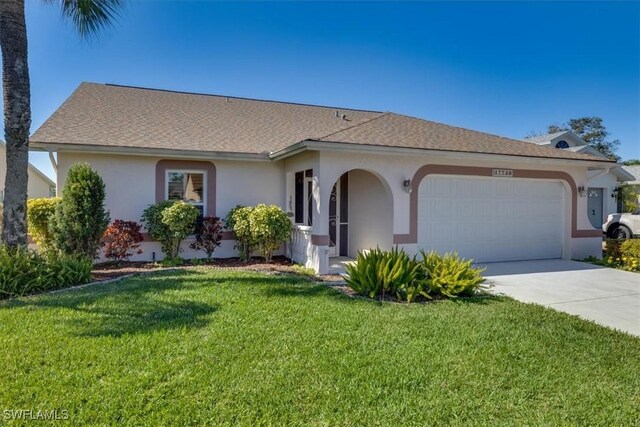 view of front facade with a garage and a front lawn