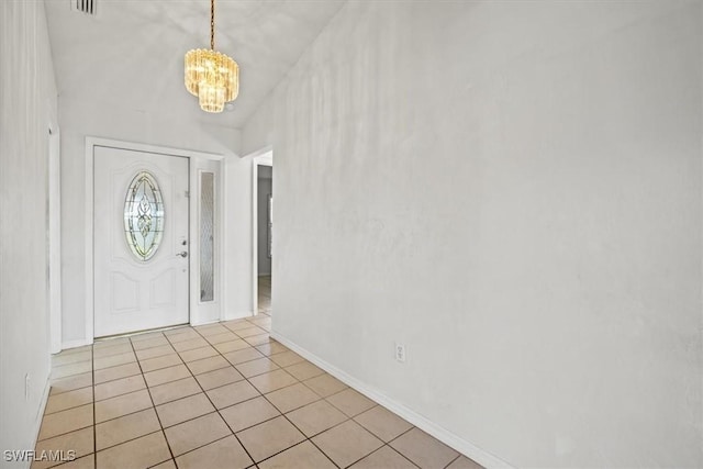 foyer with a notable chandelier and light tile patterned floors