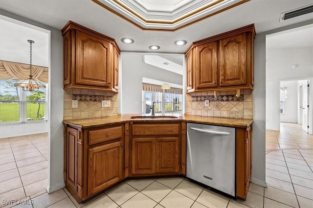 kitchen with tasteful backsplash, dishwasher, ornamental molding, and sink