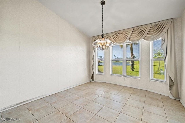 unfurnished dining area with light tile patterned floors and a notable chandelier