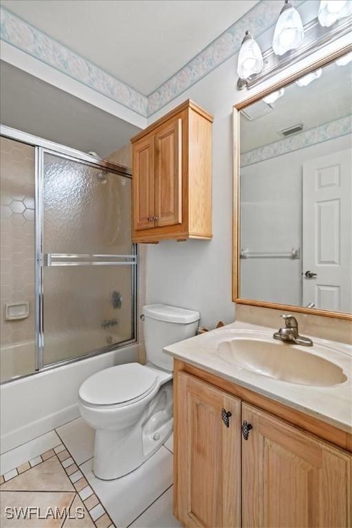 full bath featuring visible vents, toilet, combined bath / shower with glass door, vanity, and tile patterned floors