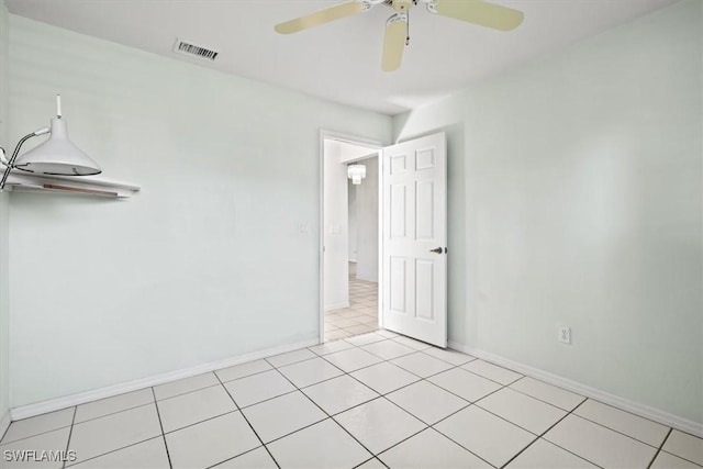 interior space with ceiling fan and light tile patterned flooring