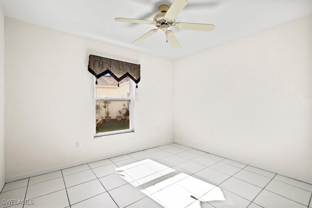 unfurnished room with ceiling fan and light tile patterned floors