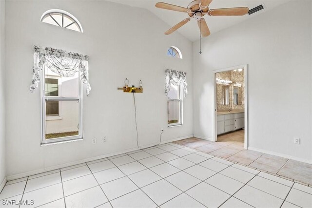 spare room featuring high vaulted ceiling, ceiling fan, and light tile patterned flooring