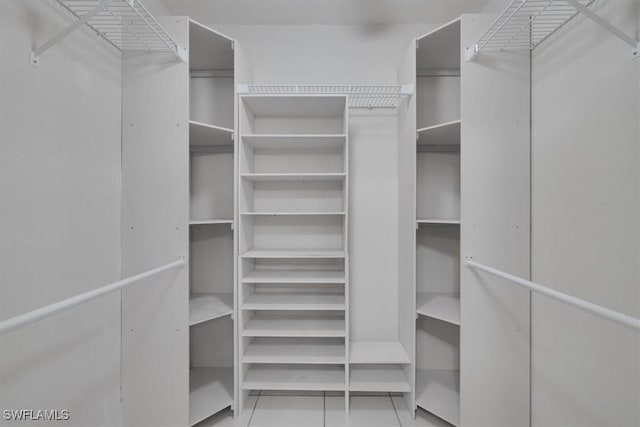 spacious closet with light tile patterned flooring