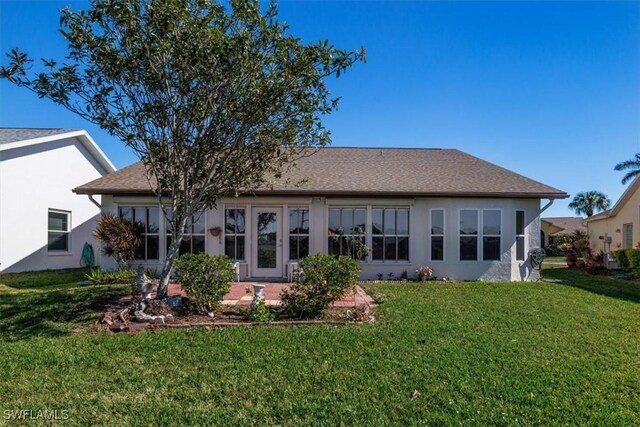 back of property featuring a patio area and a lawn