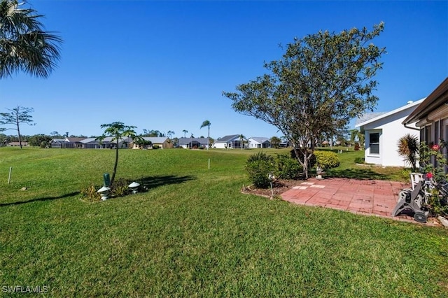 view of yard featuring a residential view and a patio