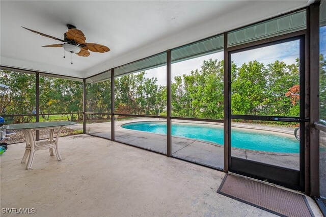 view of swimming pool featuring a patio and ceiling fan