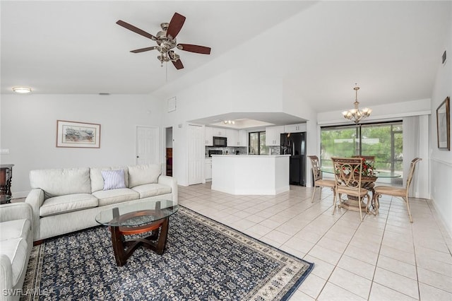 tiled living room featuring ceiling fan with notable chandelier and high vaulted ceiling