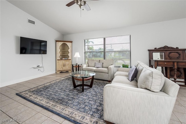 living area with visible vents, baseboards, vaulted ceiling, light tile patterned flooring, and a ceiling fan