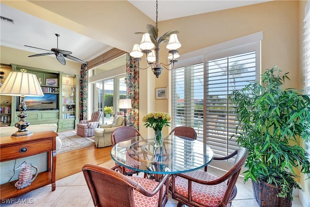 dining room featuring visible vents, crown molding, and ceiling fan with notable chandelier