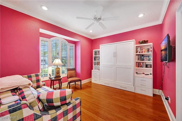 sitting room featuring recessed lighting, wood finished floors, a ceiling fan, baseboards, and crown molding